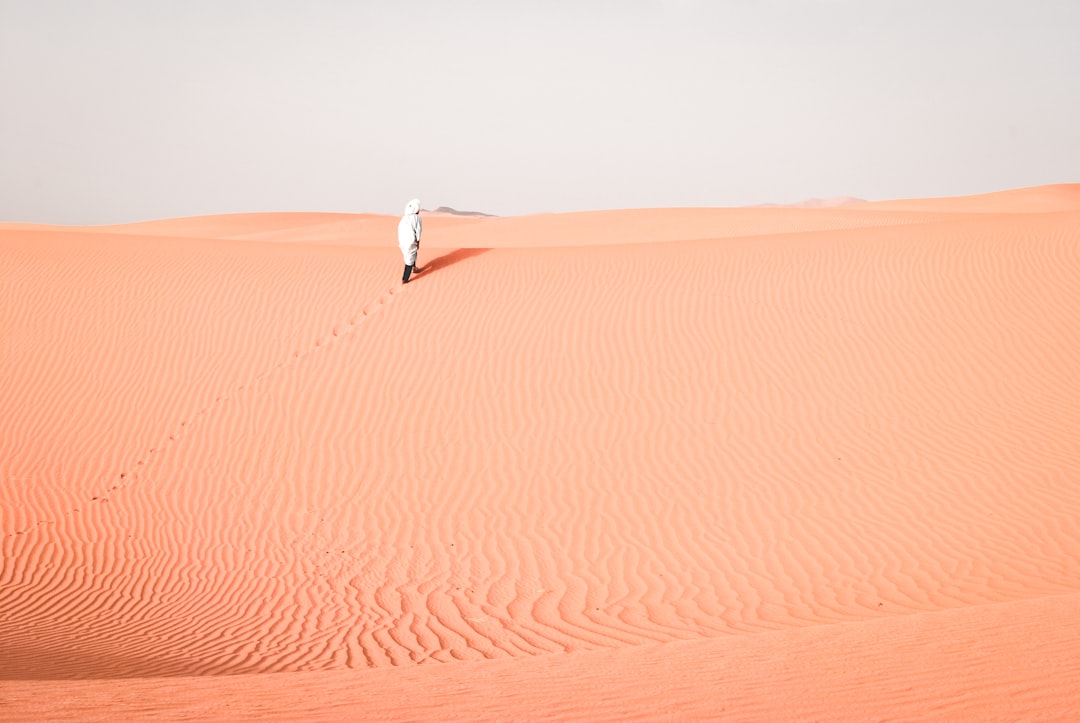 person walking on desert during daytime