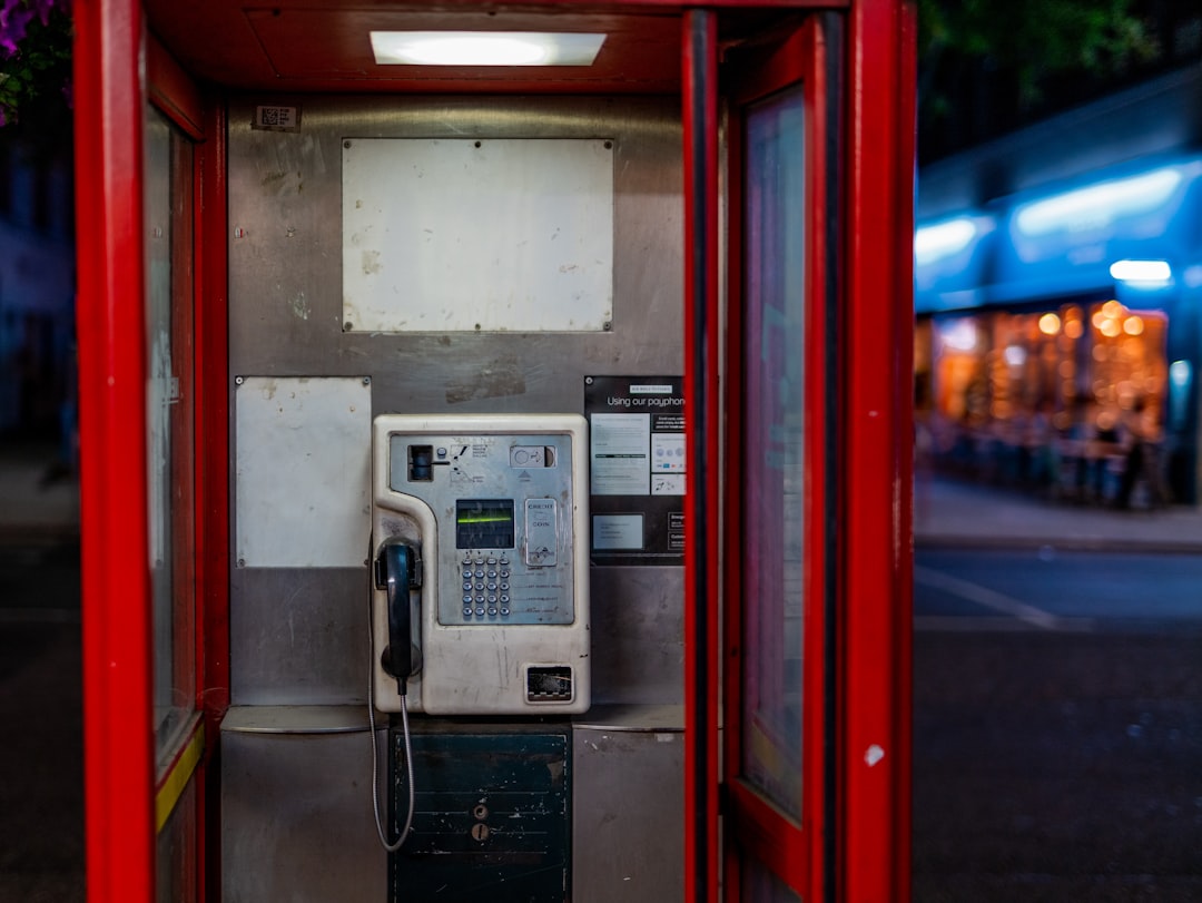 black telephone on brown wooden door